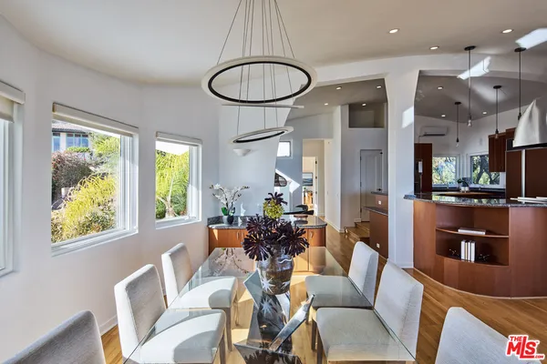 a living room with furniture a chandelier and a large window