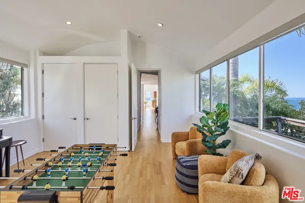 a living room with furniture and a floor to ceiling window