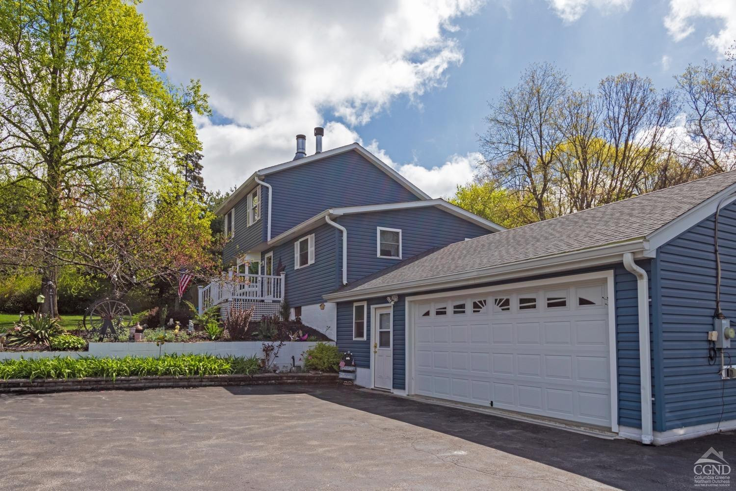 184 Snyderville Road Red Hook, NY 12571 - Photo 27 of 29 a front view of a house with a garden and trees