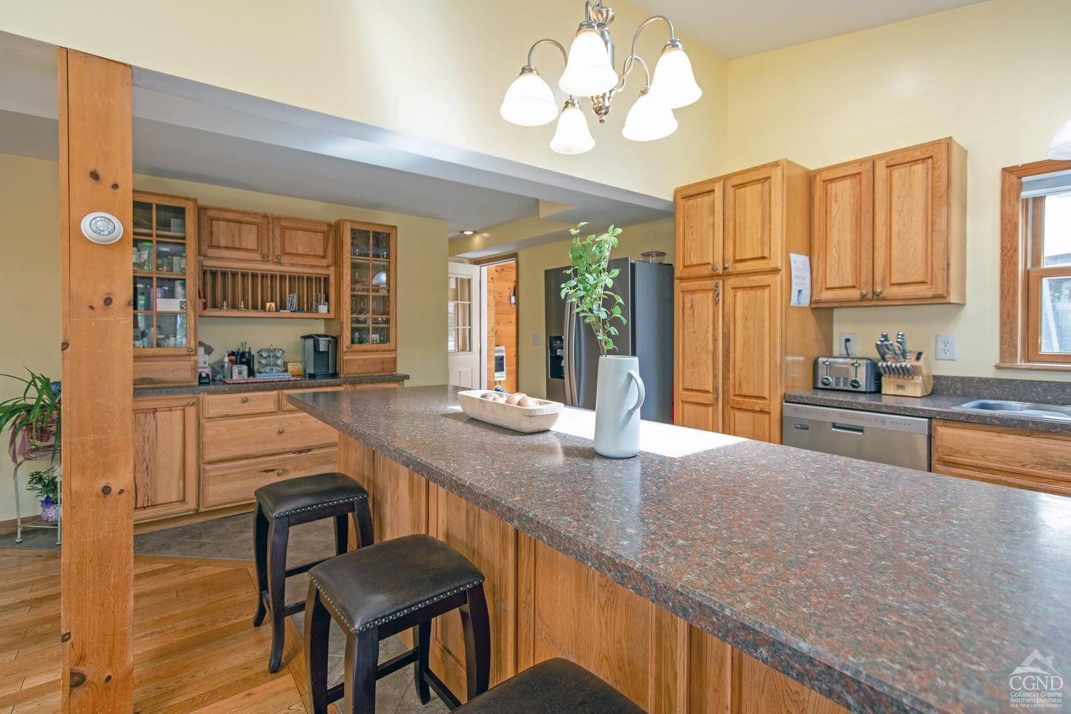 184 Snyderville Road Red Hook, NY 12571 - Photo 5 of 29 a kitchen with granite countertop a stove a sink and a refrigerator