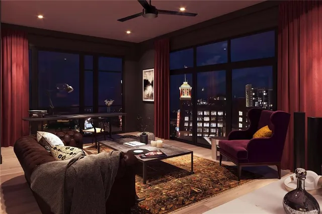 a living room with furniture rug and kitchen view