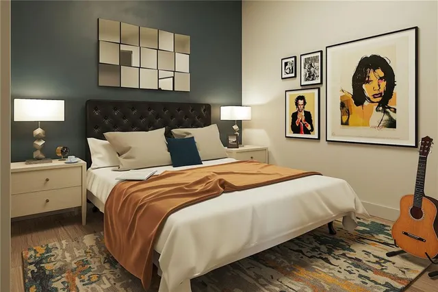 a bedroom with a bed and painting on the wall