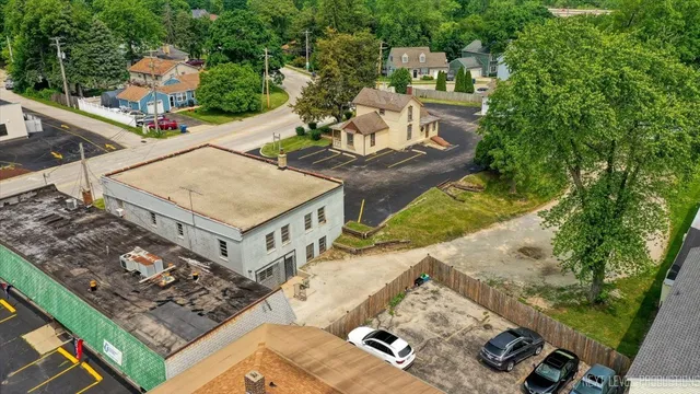 an aerial view of a house with a yard