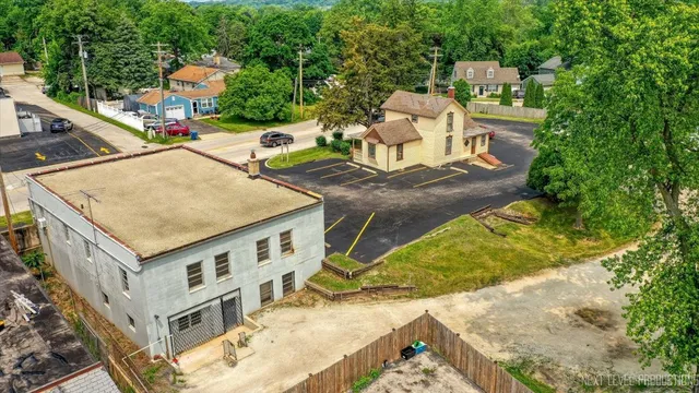 an aerial view of a house with swimming pool and furniture