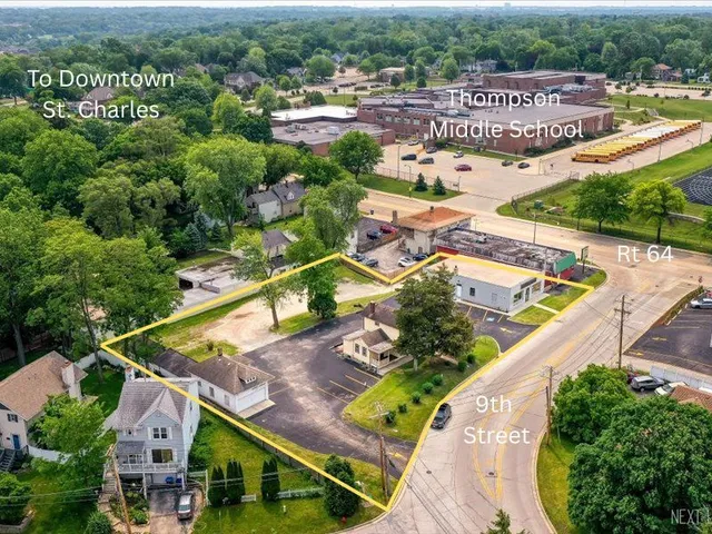 an aerial view of a house with a garden and lake view