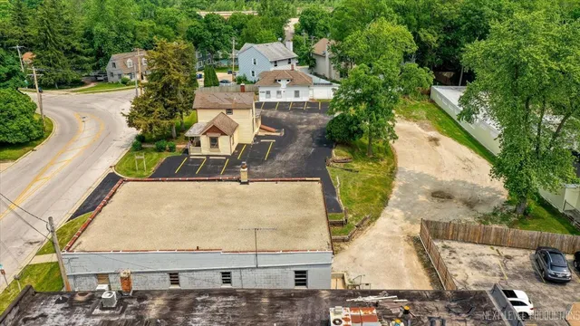an aerial view of a house with a yard and potted plants