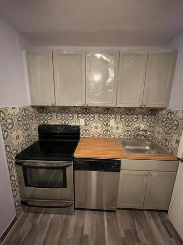 a stove top oven sitting inside of a kitchen