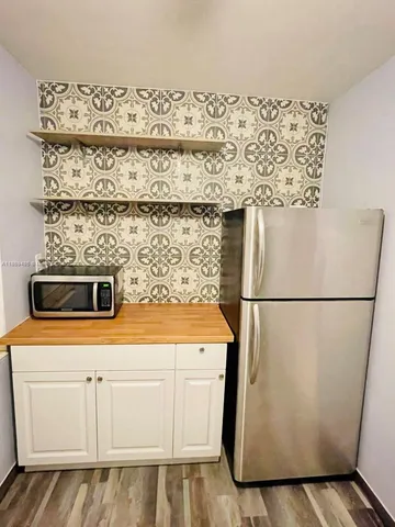 a white refrigerator freezer sitting inside of a kitchen