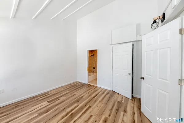 a view of a room with wooden floor