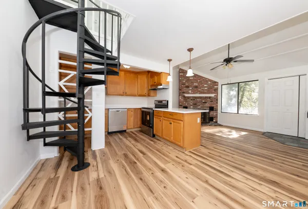 a view of kitchen with furniture and wooden floor