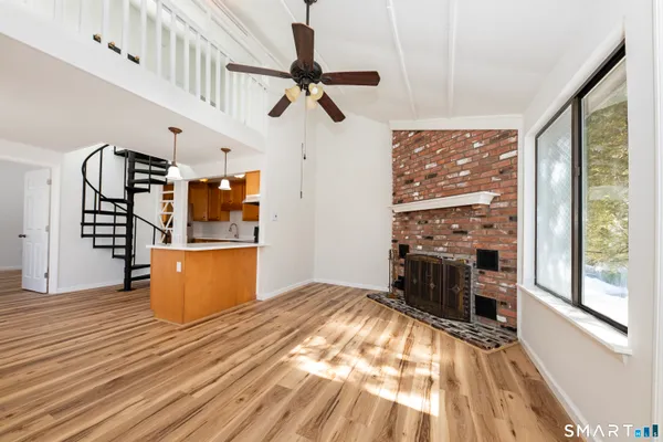 a view of workspace with wooden floor and windows