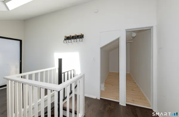 a view of staircase with wooden floor