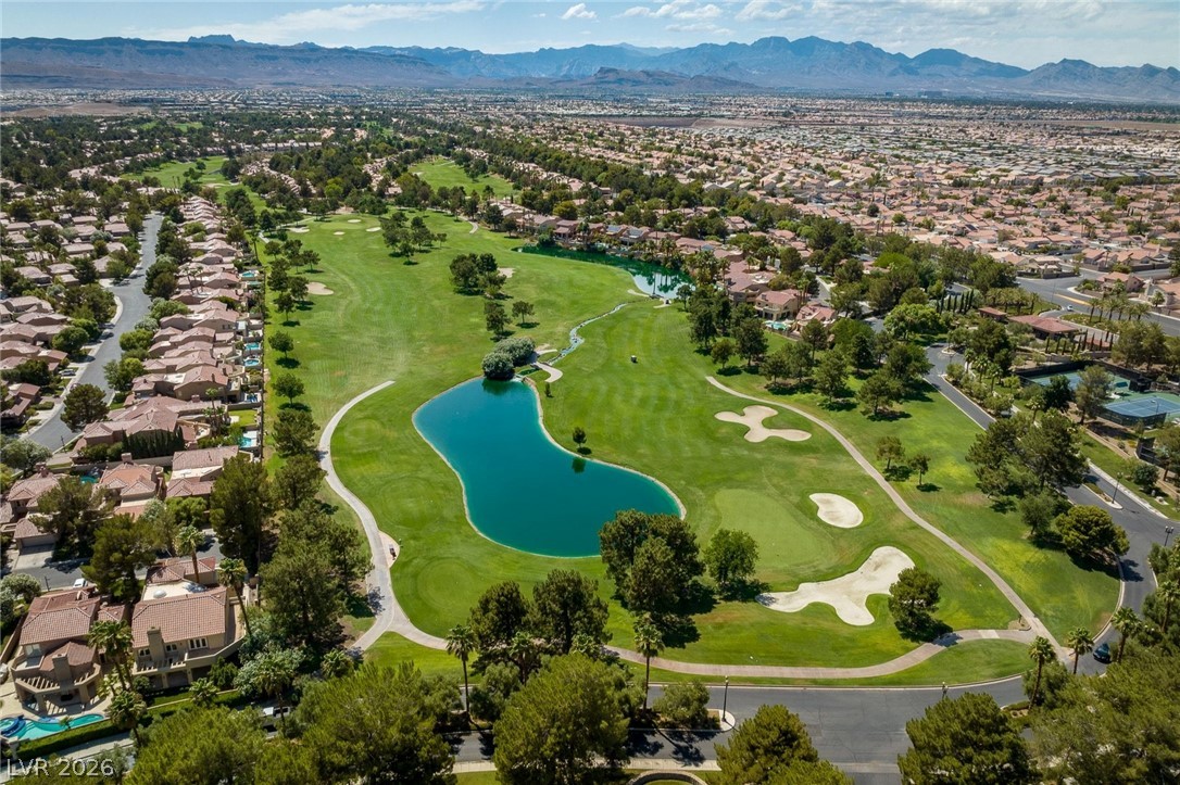 20 Innisbrook Avenue Las Vegas, NV 89113 - Photo 31 of 39 Aerial view showcasing a lush golf course with serene water features and surrounding residential community.