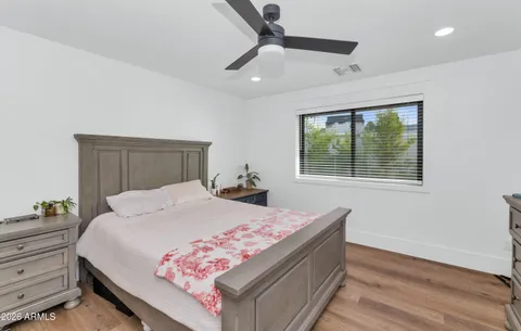 a bedroom with a bed and wooden floor