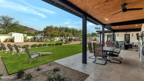 a view of a house with a swimming pool and sitting area