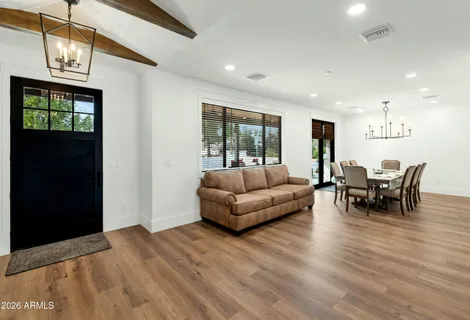 a view of a dining room with furniture and wooden floor