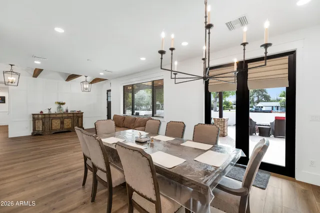 a dining room with furniture and wooden floor