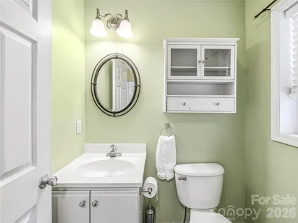 a bathroom with a sink mirror and toilet