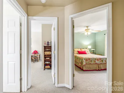 a view of a bedroom with bed and window