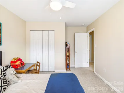 a bed room with a bed and a painting on the wall