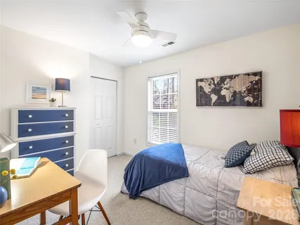 a bedroom with furniture and a window