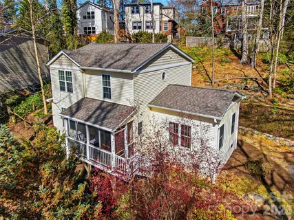 a aerial view of a house with swimming pool and sitting area