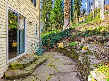 a view of a chairs and table in backyard
