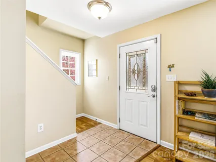 a view of a hallway with closet and a window