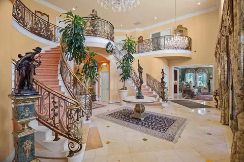 a large kitchen with stainless steel appliances a large counter top a stove and a sink