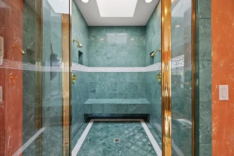 a bathroom with a granite countertop sink a toilet and a mirror