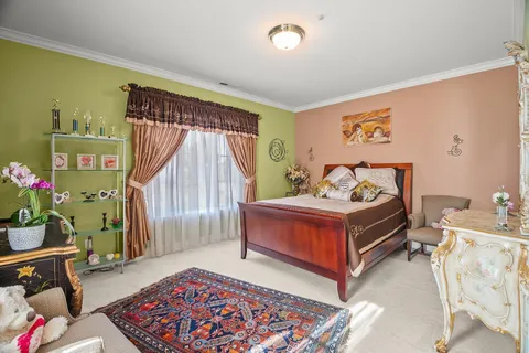 a patio with a table and chairs and potted plants