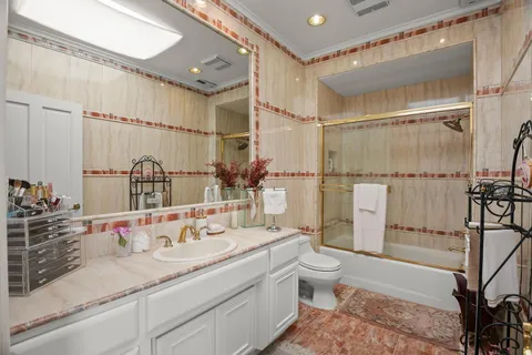 a view of swimming pool with lounge chair and dinning table under an umbrella