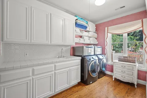 a dining room with furniture a rug and a painting