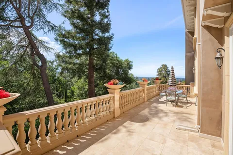 a view of a house with a garden and deck