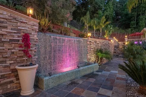 a view of a swimming pool with a patio and a yard