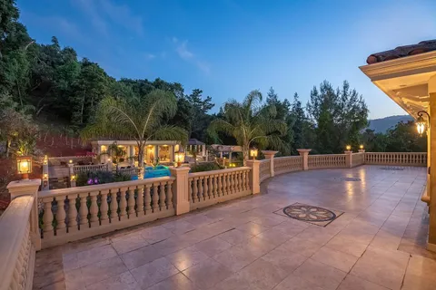 an aerial view of a house with a swimming pool and garden