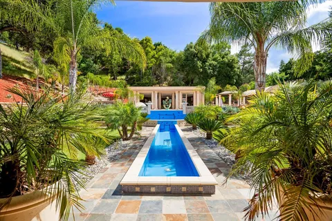 a front view of a house with a garden