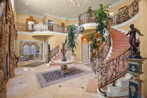 a living room with furniture a fireplace and a chandelier