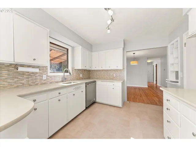 a kitchen with a sink cabinets and window