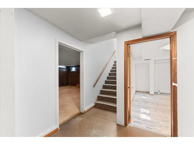 a view of a hallway with wooden floor and entryway