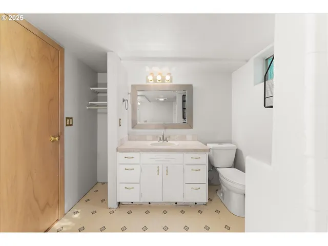 a bathroom with a sink a toilet and a mirror