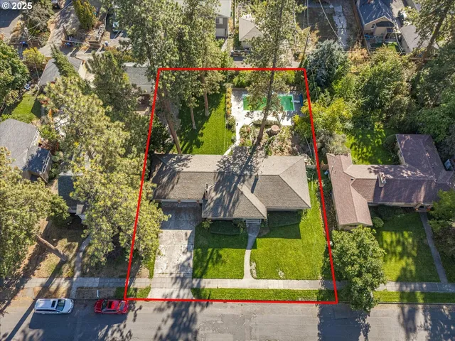 an aerial view of a house with a yard swimming pool and outdoor seating
