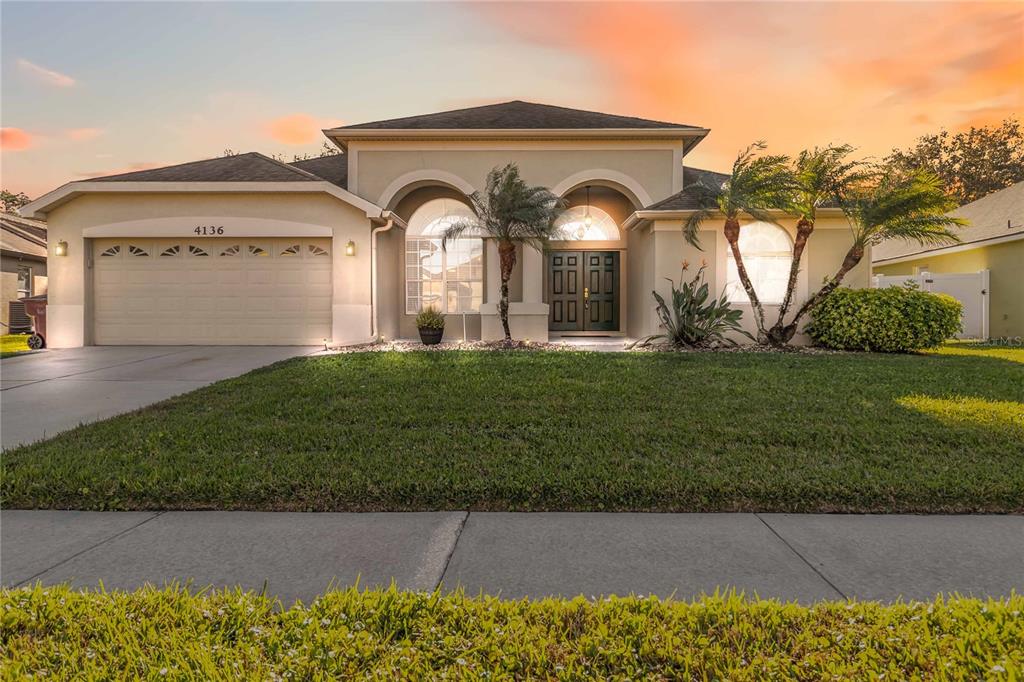 4136 Maidu Court St. Cloud, FL 34772 - Photo 1 of 40 a front view of a house with a yard and garage