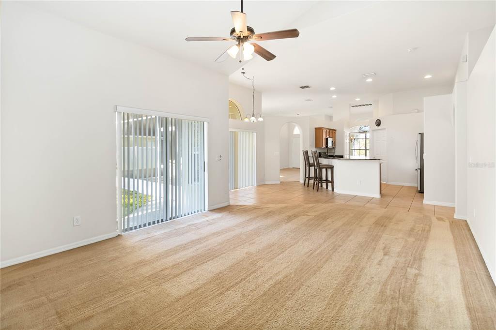 4136 Maidu Court St. Cloud, FL 34772 - Photo 15 of 40 a view of empty room with wooden floor and fan
