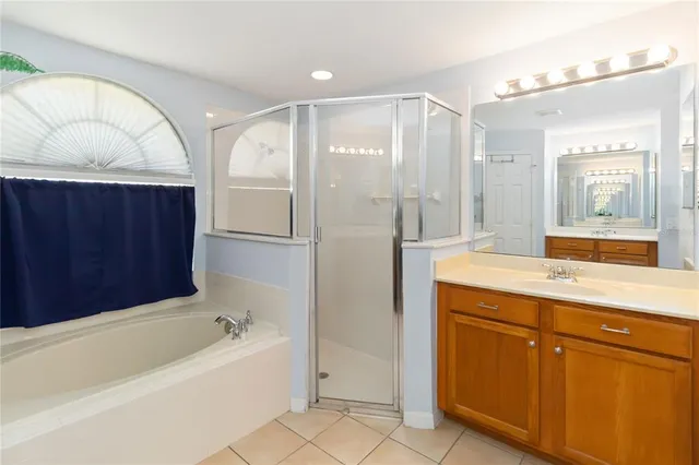 a bathroom with a bathtub sink and mirror