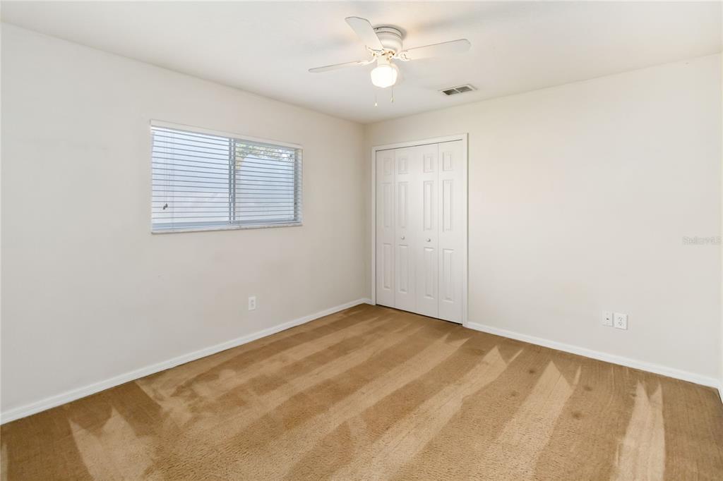 4136 Maidu Court St. Cloud, FL 34772 - Photo 27 of 40 an empty room with a window and a fan