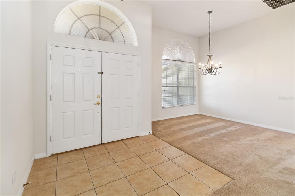 4136 Maidu Court St. Cloud, FL 34772 - Photo 3 of 40 an empty room with kitchen view and wooden floor