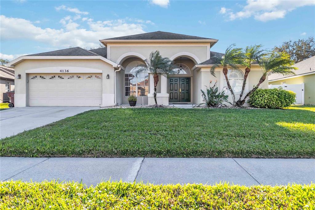 4136 Maidu Court St. Cloud, FL 34772 - Photo 38 of 40 a view of a grey house with a yard