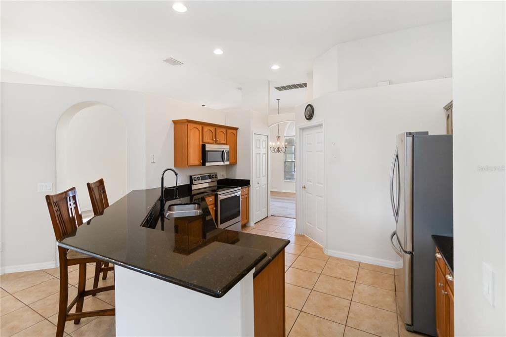 4136 Maidu Court St. Cloud, FL 34772 - Photo 9 of 40 a kitchen with a table chairs and refrigerator