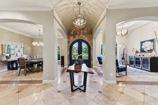 a living room with furniture a fireplace and a chandelier
